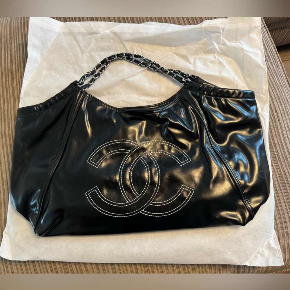 Black knock off ‘Chanel’ bag. blank exterior brown liner with Chanel fabric.